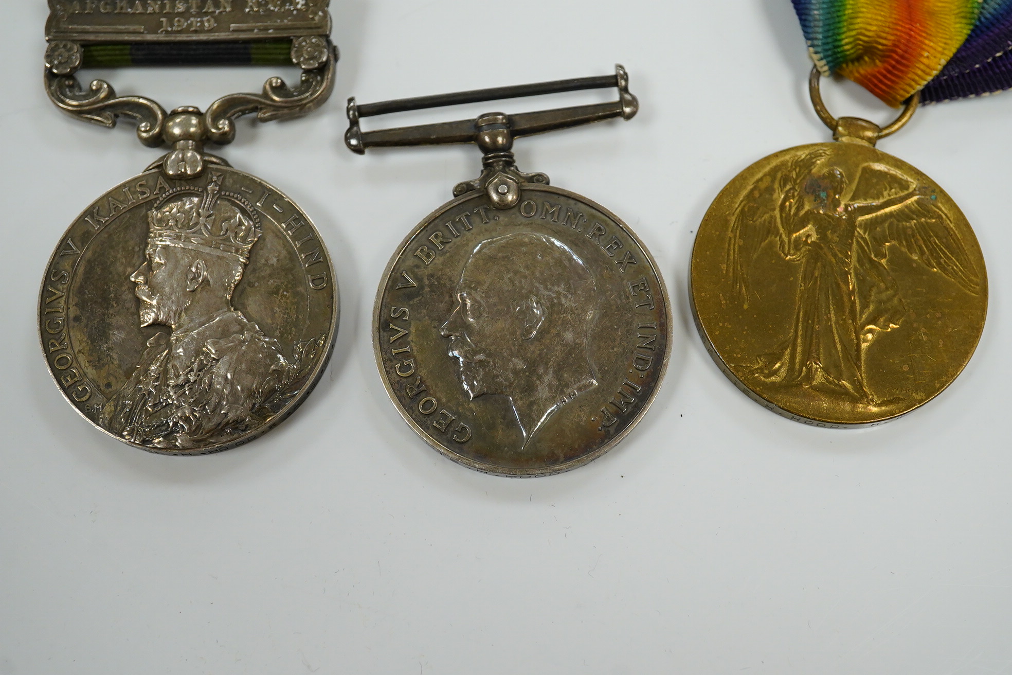 A First World War three medal group awarded to Pte. H. Hood R.W. Kent comprising; an India medal with bar for Afghanistan N.W.E. 1919, a War Medal and Victory Medal, plus an additional Victory Medal awarded to 2. Lieut.